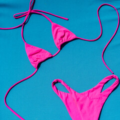 From Above Photo Of Pink Bikini On A Blue Background