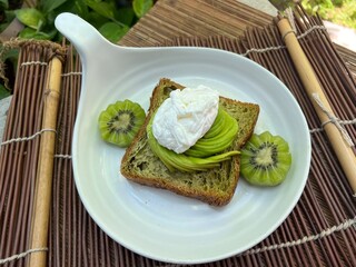 Matcha croissant loaf with avocado and soft egg and kiwi fruit