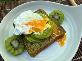 Matcha croissant loaf with avocado and soft egg and kiwi fruit