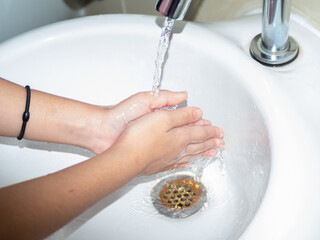 woman washing hands in bathroom