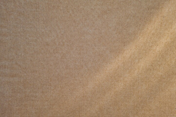 Blank beige cardboard texture with sunrays. Abstract background. Recycled paper, environmentally friendly raw materials.