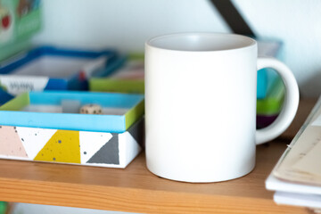 White mug on shelf in play room - 525352240