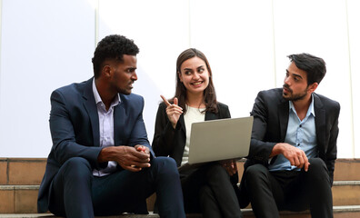 Fototapeta premium Portrait Businessman and woman sitting on a laptop outside the office