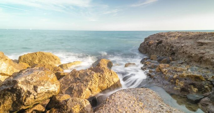 4K Timelapse view of the waves crashing on the rocks in the sea of Anzio, Rome, Italy
