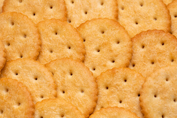 Healthy whole wheat cracker on white background. Stack of Saltine crackers isolated on white background. Round crackers.