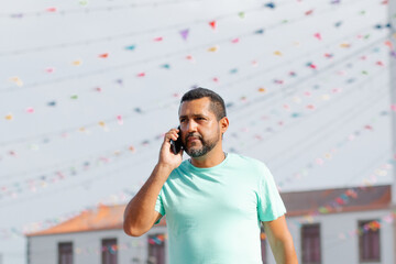 handsome young man using his smartphone in city