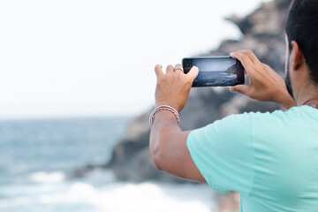 handsome young man using his smartphone in city