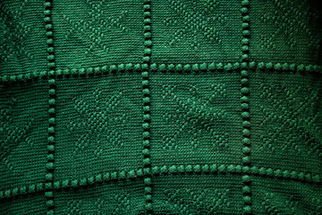 green knitted or crocheted snowflake blanket