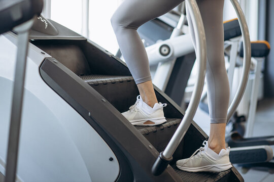 Woman walking on stepmill at the gym
