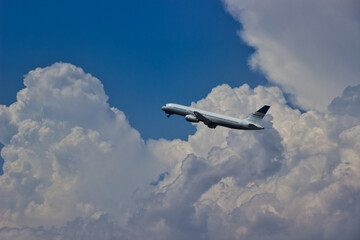 Fototapeta na wymiar plane leaving the terminal between clouds
