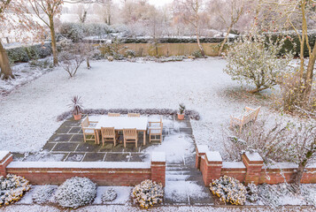 Snow covered garden in UK winter, snowy backyard scene