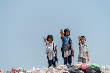 Poor children collecting garbage for sale Concept of pollution and Environment recycling old waste...