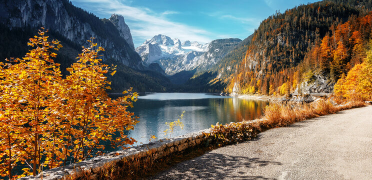 Stunning Landscape of Alpine Lake. Gosausee Vorderer lake and Dachstein mount Under sunlight. Gosau Valley. Dachstein glacier. Amazing nature scenery. Popular travel and hiking destination.