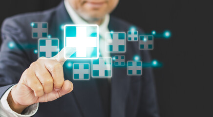 Business healthy and medical care insurance concept, professional Businessman finger pressing symbol cross shape with the shield icon and over gradient light blue, copy space on left, black background