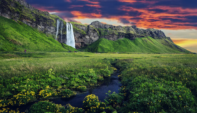 Scenic image of Iceland. Fantastic colorful Scenery of Iceland. Incredible Seljalandsfoss waterfall with dramatic picturesque sky during sunset. Wonderful Nature landscape. Popular Travel destinations