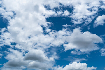 Obraz premium Clouds with blue sky background. Natural fluffy white clouds in clear beautiful dramatic blue sky.