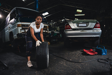 Fototapeta na wymiar Female mechanic wearing gloves checking wheels and tires.