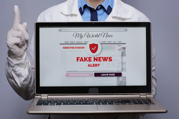 Female medical doctor showing laptop with monkeypox fake news