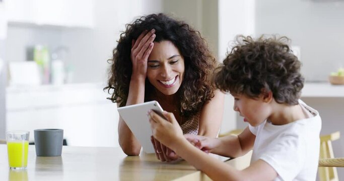 Online education, learning and fun with a single mother and son looking excited, wow, surprised as a family by tablet content. Website, internet and technology with a woman and child in the kitchen