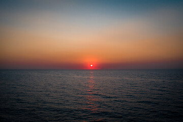 Golden sunset in the italian sea from the water
