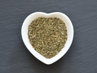 Image of thyme, marjoram, oregano, parsley, sage and basil mixed in a bowl.