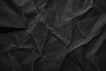 Heavy crumpled black paper texture background