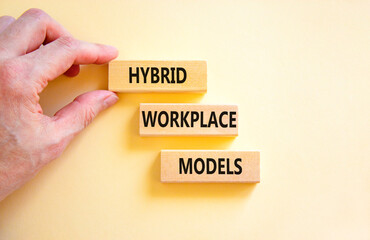 Hybrid workplace models symbol. Concept words Hybrid workplace models on wooden blocks. Businessman...