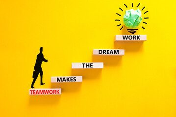 Teamwork makes dream work symbol. Concept words Teamwork makes the dream work on wooden blocks on beautiful yellow background. Businessman icon. Business Teamwork makes dream work concept. Copy space.