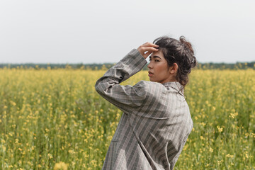 An Asian model poses in a field of yellow flowers for a clothing brand, polyethylene is the main...