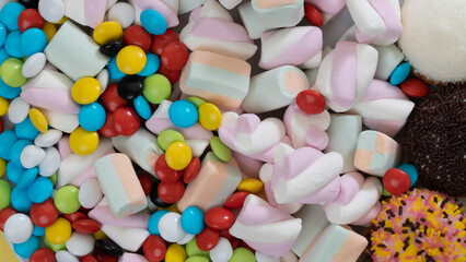 Sweets, dragees, marshmallows, cakes close-up - a background of sweets