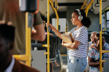 Student listening music in public bus