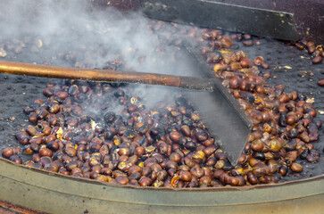 roasted chestnuts cooked on the grill in autumn - 525377879
