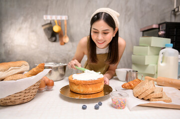 Young beautiful woman is baking in her kitchen , bakery and coffee shop business