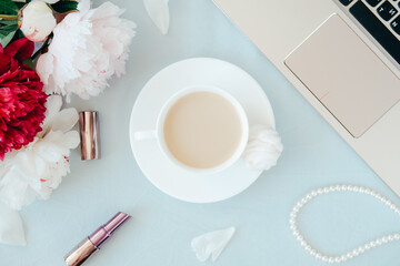Modern home office concept. Computer, coffee and flowers.
