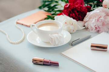 Modern home office concept. Computer, coffee and flowers.