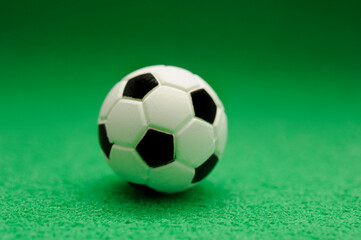 Fototapeta na wymiar miniature soccer ball on green, design element