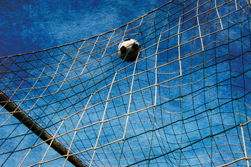 soccer ball entering the net, scoring a goal