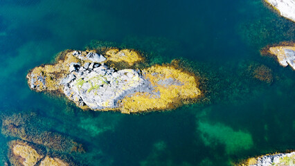 Aerial view of sea waves and fantastic rocky shore. Reefs and algae near the shores of the Norwegian Sea. Norway