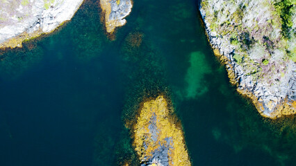 Aerial view of sea waves and fantastic rocky shore. Reefs and algae near the shores of the Norwegian Sea. Norway