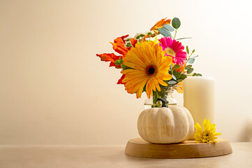 Stil life flowers and pumpkin. Bouquet of fresh flowers, candle and decorative pumpkins. Autumn...