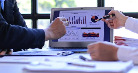 Successful teamwork Financial analysts analyze business financial reports on a digital tablet planning investment project during a discussion of corporate showing the results of their workspace 