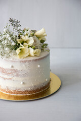 White wedding cake Birthday cake covered with american buttercream and cake topper