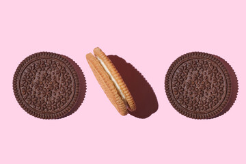 Pattern of cookies. Cookies on a pink background. Flat lay. sandwich cookies filled with sweet cream. Sweet cookies flat lay pattern on light pink background. Top view.