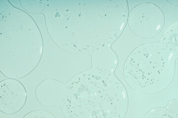 Top view of liquid cosmetics gel with bubbly structure on pastel cyan background.Good as cosmetic...