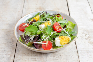 Fresh salad with cherry tomato, cabbage , boiled eggs and fresh lettuce. Ketogenic diet breakfast. Keto, paleo salad.