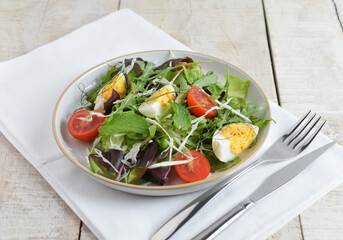 Fresh salad with cherry tomato, cabbage , boiled eggs and fresh lettuce. Ketogenic diet breakfast. Keto, paleo salad.