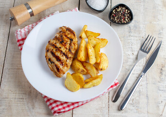 Grilled chicken breast, fillet, steak and fresh vegetable salad, top view. Healthy keto, ketogenic lunch menu with chicken meat and organic veggies and greens. Wooden table. Flat lay