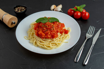 Tasty colorful appetizing cooked spaghetti italian pasta with tomato sauce and fresh basil.