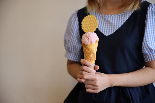Young woman hand with holding ice cream cone