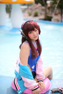 Portrait of Japan anime cosplay girl with swim suit at swimming pool